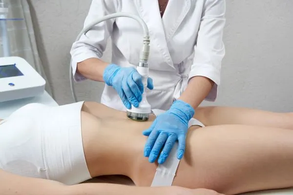 Lost the Weight but Not the Loose Skin? 2 woman having HIFU treatment on her stomach to combat loose skin Bridgend following weight loss